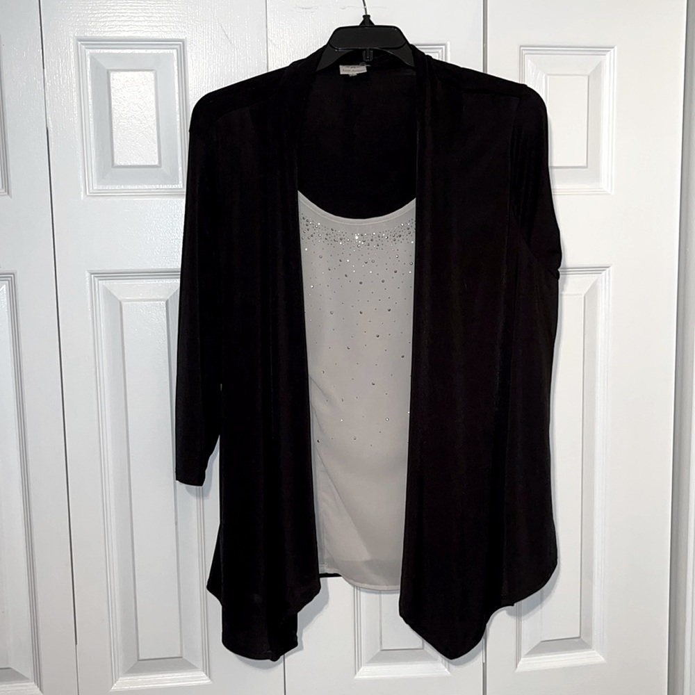White shirt with black cardigan.